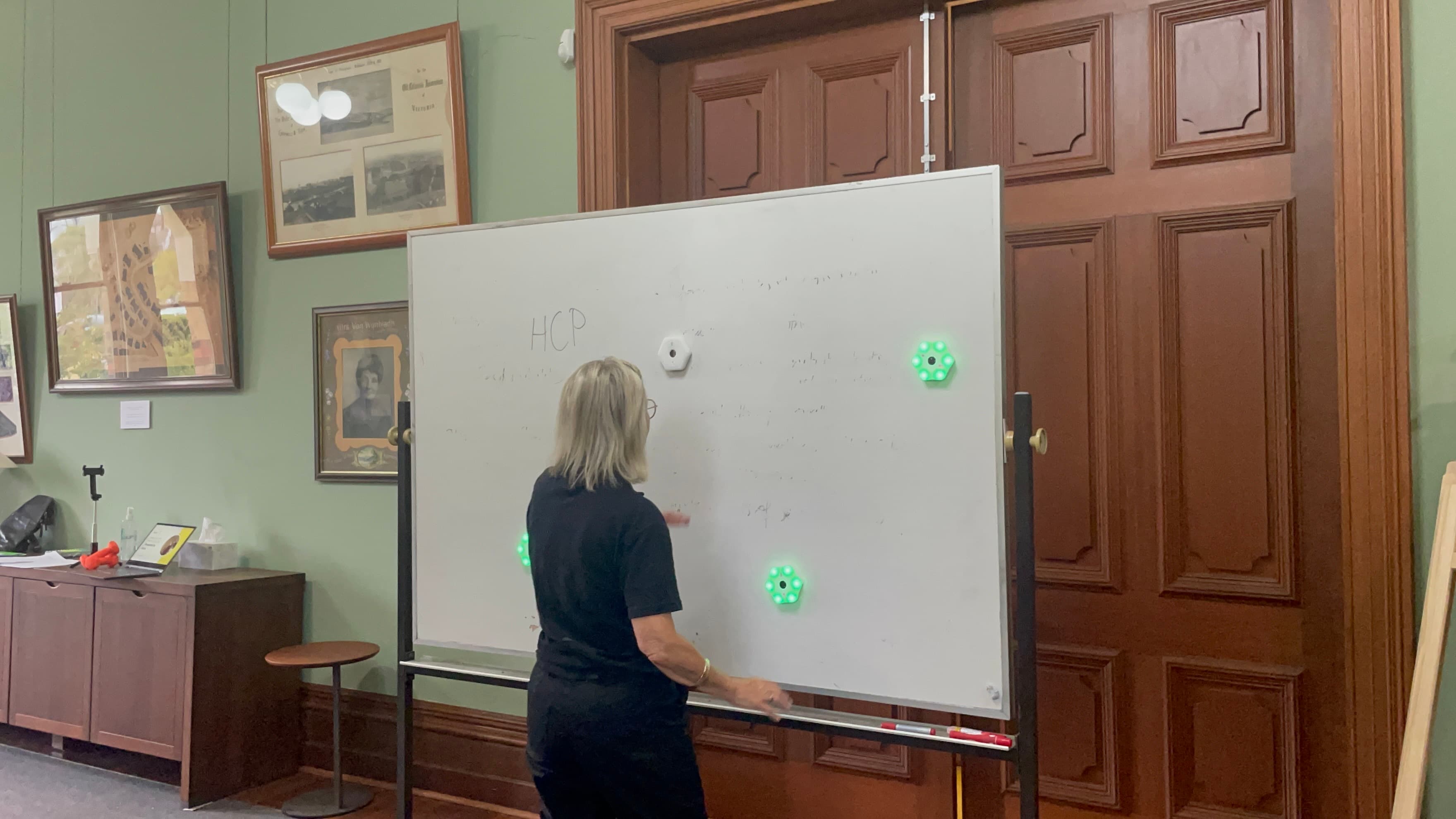 Bryta clinician using the Bryta device lights on a whiteboard